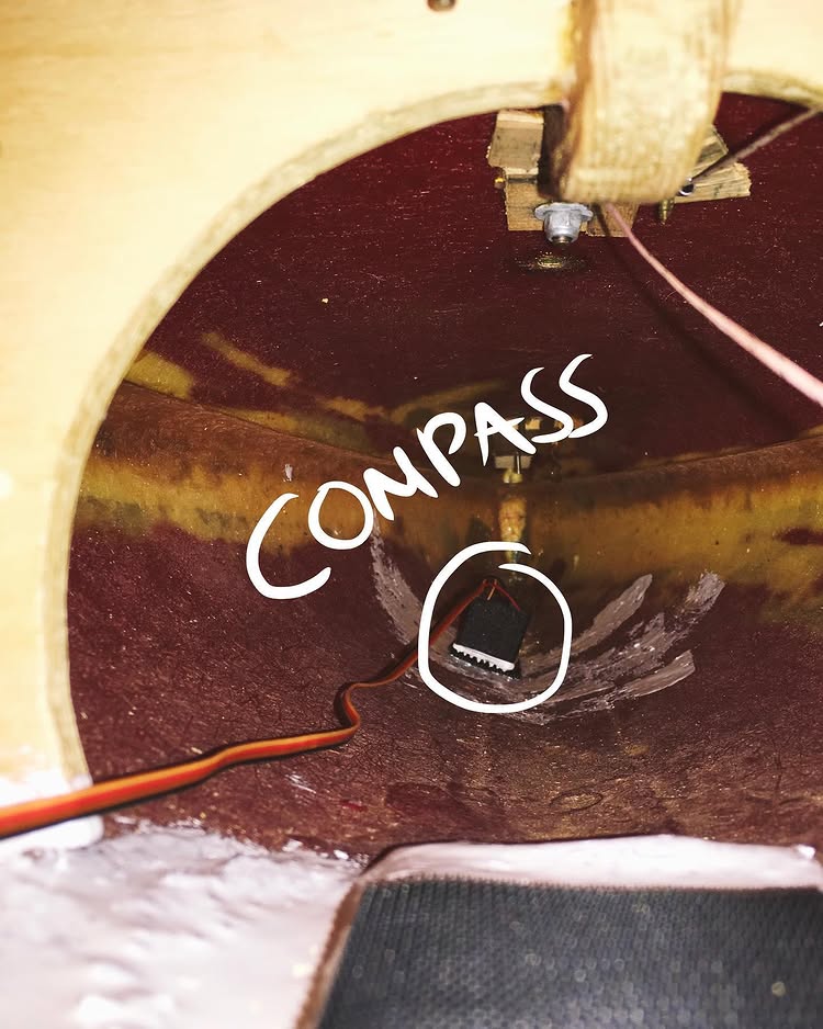 inside of the boat showing compass in the bow