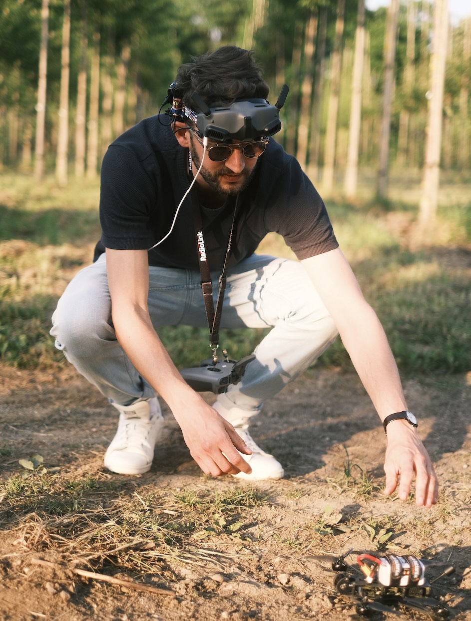 Manuel with an FPV drone in a field